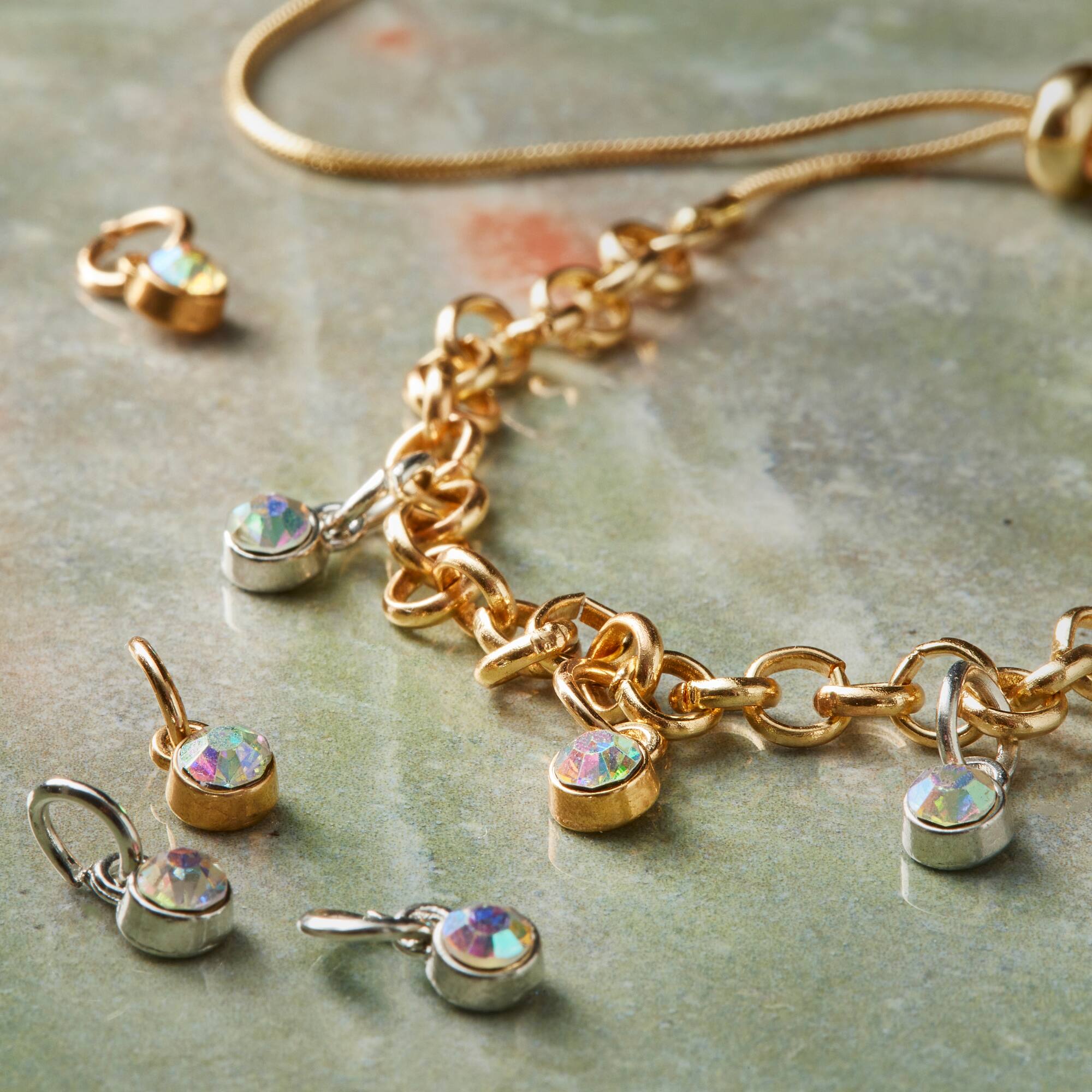 12 Packs: 24 ct. (288 total) Charmalong™ Crystal AB Drop Charms by Bead Landing™